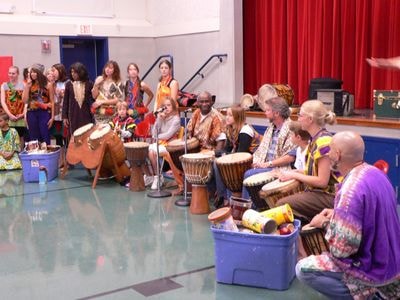 Drummers in a semi-circle in a gym